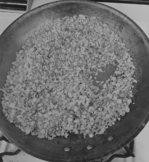 Farfel being browned in butter. Black and white photo.