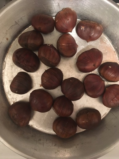 Chestnuts before roasting in pan