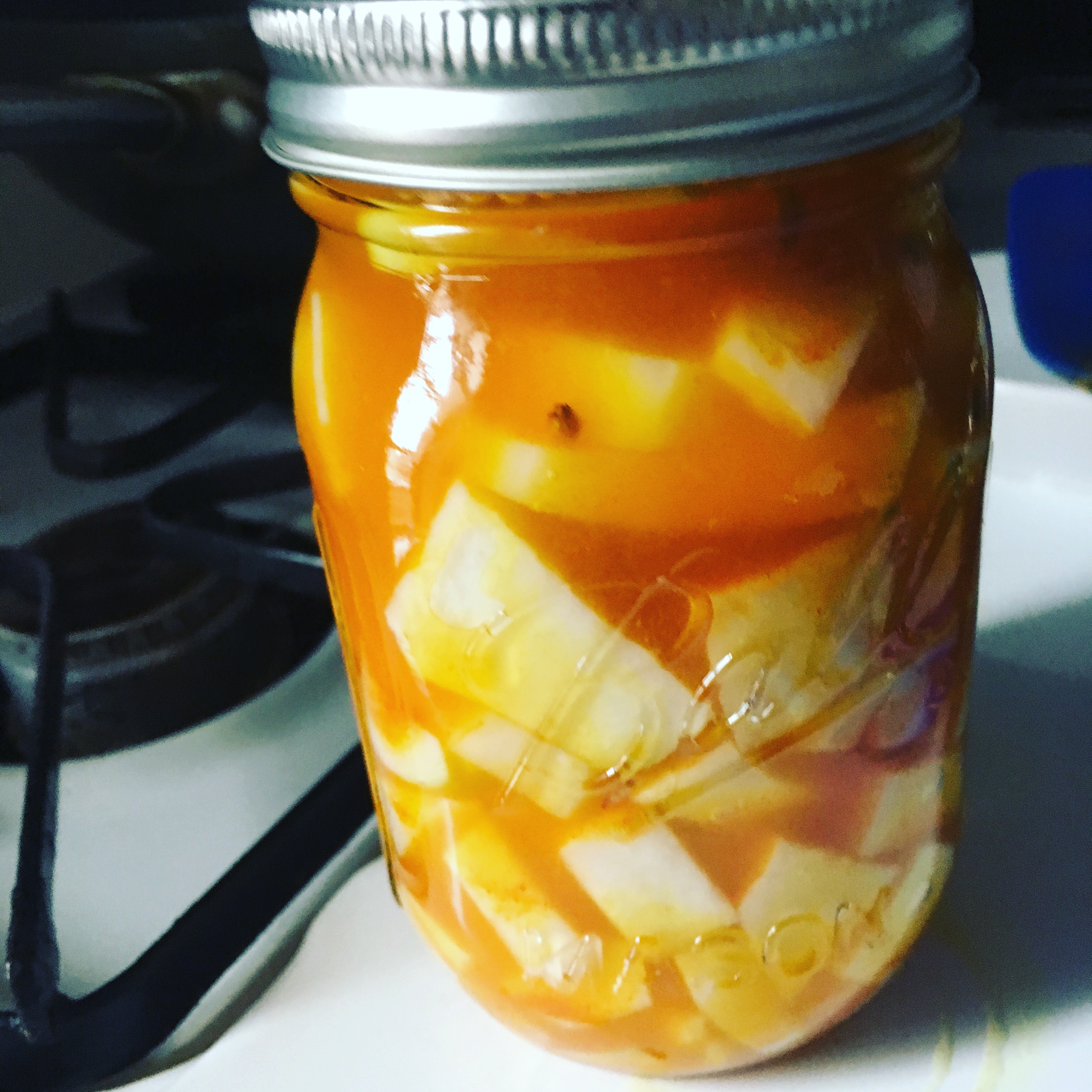 Pickled kohlrabi and turnip in an orange brine