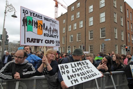 Disability rights protest in Ireland. Signs include "10 years waiting for equality ratify CRPD now" and "No limbs. No limits. Impossible. I'm possible."