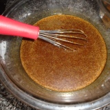 Molasses and sugar and oil in a bowl, brown mixture